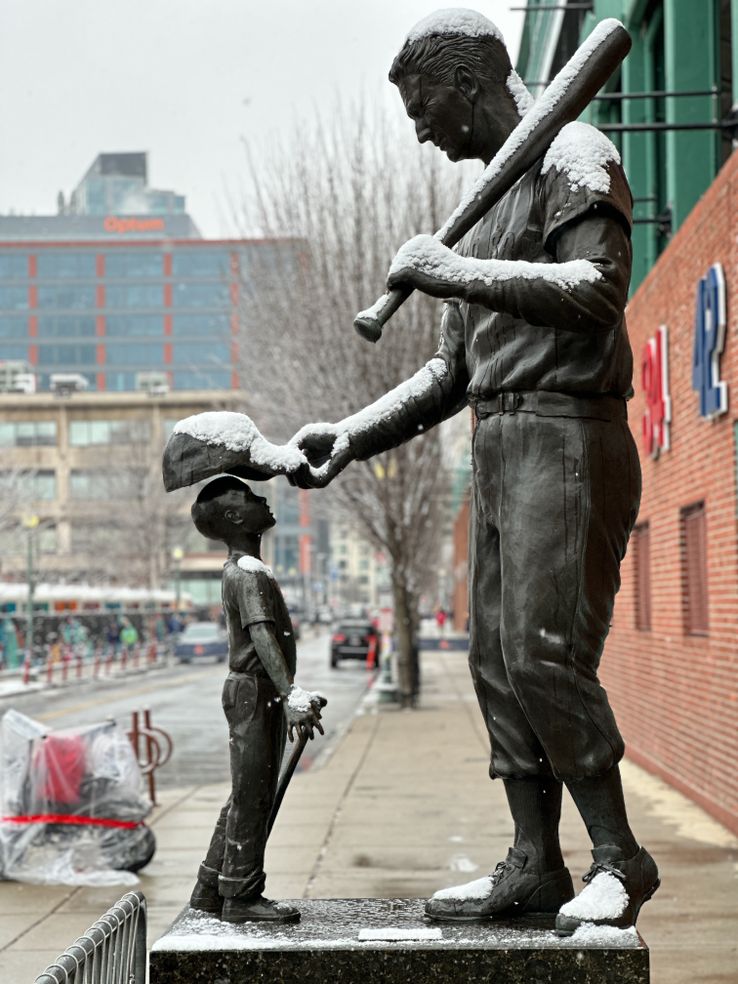 Statue of Ted Williams placing his cap on a little boy