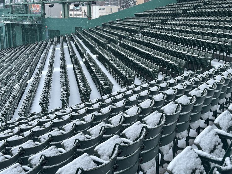 Center and right field bleacher seats covered with snow.